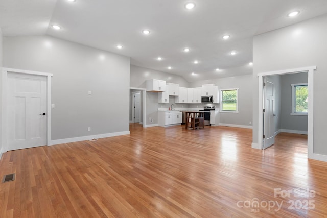 1844 Bellcroft Ln, Lenoir, NC 28645 - living room featuring vaulted ceiling, light wood finished floors, and recessed lighting