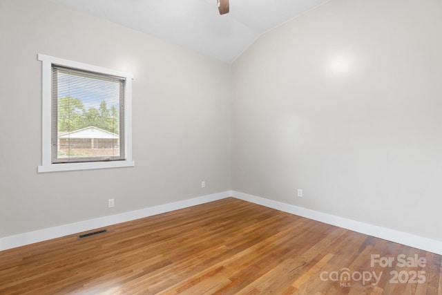 1844 Bellcroft Ln, Lenoir, NC 28645 - empty room with vaulted ceiling, a ceiling fan, and wood finished floors