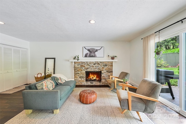 19 Poplar Ct, Hendersonville, NC 28792 - living room featuring a textured ceiling, wood finished floors, a fireplace, and recessed lighting