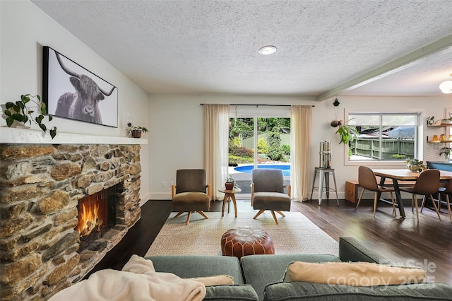 19 Poplar Ct, Hendersonville, NC 28792 - living area featuring a textured ceiling, wood finished floors, and a fireplace