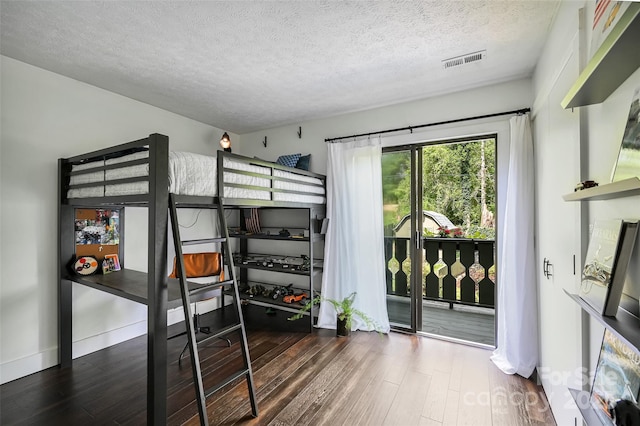 19 Poplar Ct, Hendersonville, NC 28792 - bedroom featuring wood finished floors, access to exterior, and a textured ceiling