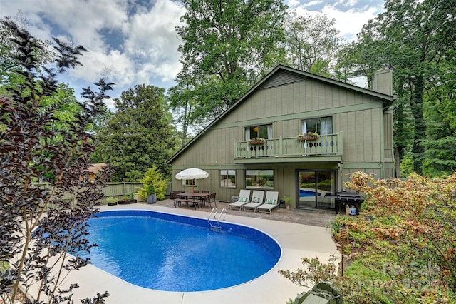 19 Poplar Ct, Hendersonville, NC 28792 - rear view of property featuring a balcony, a chimney, a patio area, and outdoor dining space
