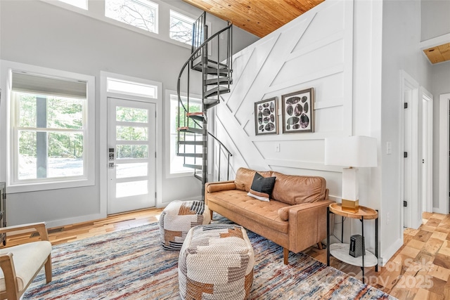 163 Hawk Hollow Dr, Lake Lure, NC 28746 - living room featuring healthy amount of natural light, stairs, a towering ceiling, and wood finished floors