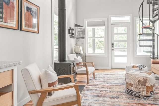 163 Hawk Hollow Dr, Lake Lure, NC 28746 - sitting room featuring a wood stove and wood finished floors