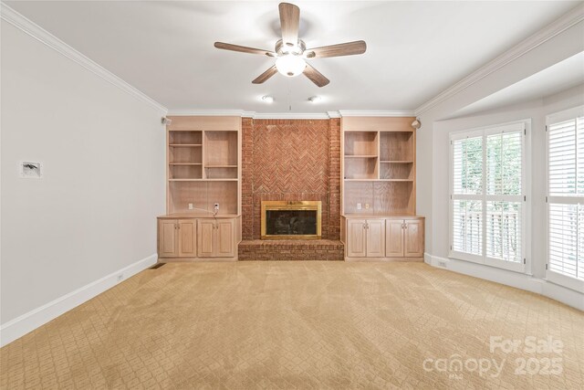 7301 Leharne Dr, Charlotte, NC 28270 - unfurnished living room with a ceiling fan, ornamental molding, a fireplace, built in shelves, and light carpet