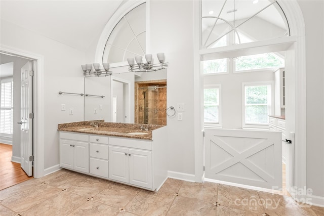 7301 Leharne Dr, Charlotte, NC 28270 - bathroom with double vanity, a shower with shower door, and high vaulted ceiling