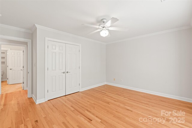 7301 Leharne Dr, Charlotte, NC 28270 - unfurnished bedroom with crown molding, light wood-style floors, a closet, and ceiling fan