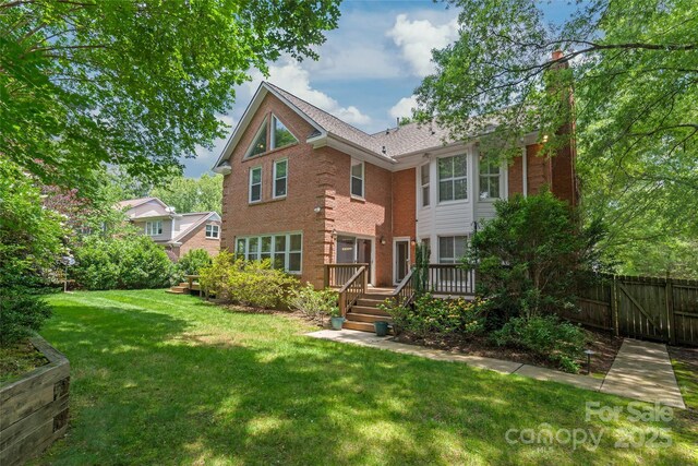 7301 Leharne Dr, Charlotte, NC 28270 - view of front of house featuring brick siding, a deck, and a chimney