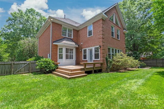 7301 Leharne Dr, Charlotte, NC 28270 - back of property featuring a wooden deck, brick siding, a fenced backyard, and roof with shingles