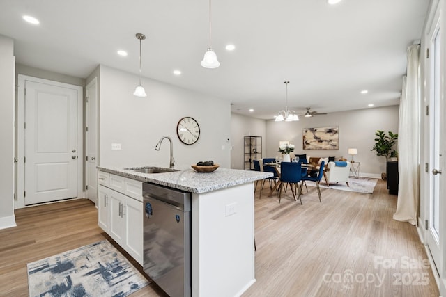384 Speedway Pl, Concord, NC 28027 - kitchen featuring dishwasher, white cabinets, light wood-style flooring, open floor plan, and an island with sink