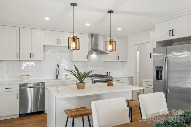 922 Maurice St, Monroe, NC 28112 - kitchen with appliances with stainless steel finishes, wall chimney range hood, decorative backsplash, light countertops, and white cabinets