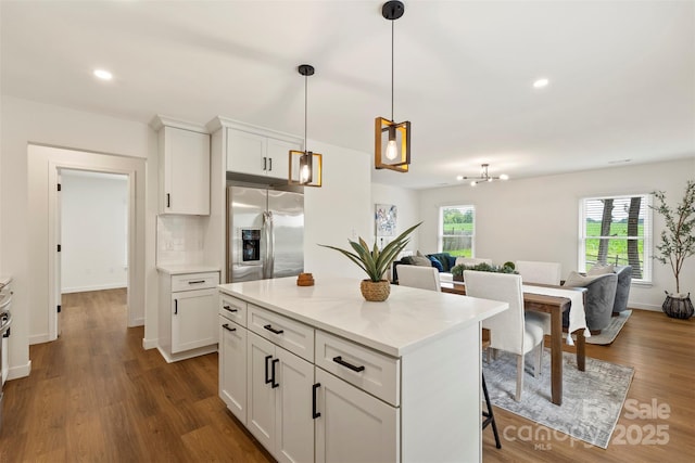 922 Maurice St, Monroe, NC 28112 - kitchen with stainless steel refrigerator with ice dispenser, white cabinets, a kitchen island, pendant lighting, and dark wood-style flooring