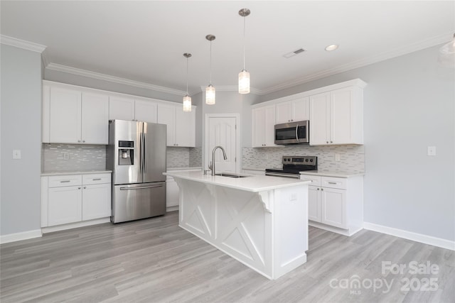 12321 Aquitaine St, Charlotte, NC 28277 - kitchen featuring appliances with stainless steel finishes, light countertops, white cabinetry, light wood finished floors, and ornamental molding