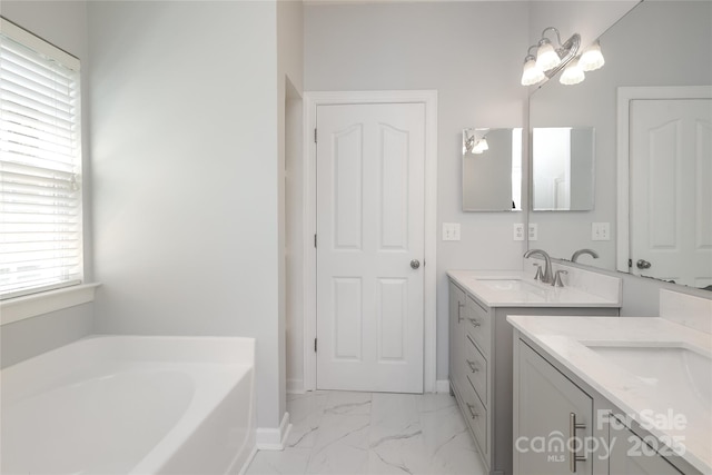 12321 Aquitaine St, Charlotte, NC 28277 - bathroom featuring two vanities, a garden tub, and marble finish flooring