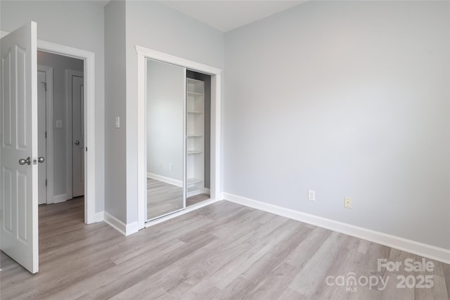 12321 Aquitaine St, Charlotte, NC 28277 - unfurnished bedroom featuring light wood-type flooring and a closet