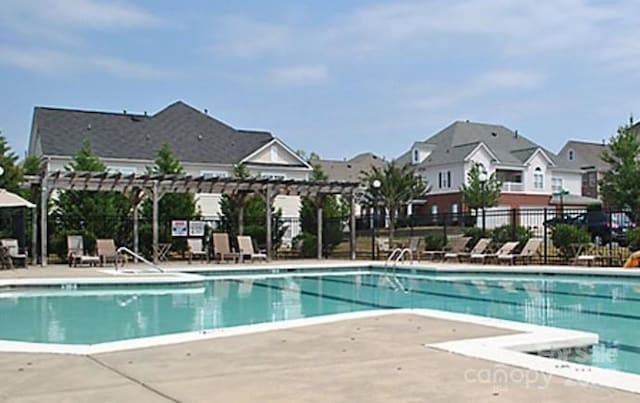 12321 Aquitaine St, Charlotte, NC 28277 - community pool with a pergola, a patio, and a residential view
