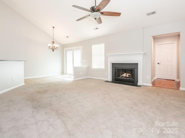 703 Bradberry Ln, Indian Trail, NC 28079 - unfurnished living room featuring a fireplace with flush hearth, light colored carpet, ceiling fan, a chandelier, and high vaulted ceiling