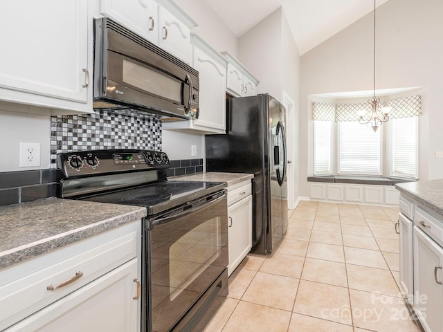 703 Bradberry Ln, Indian Trail, NC 28079 - kitchen with black appliances, lofted ceiling, a chandelier, light tile patterned floors, and white cabinets