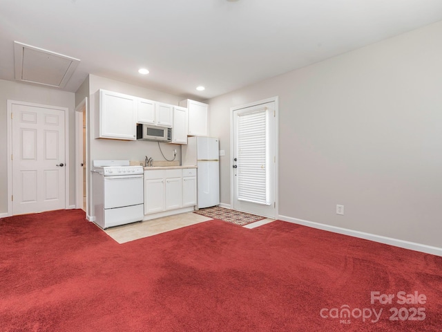 703 Bradberry Ln, Indian Trail, NC 28079 - kitchen featuring white appliances, light colored carpet, white cabinets, recessed lighting, and light countertops