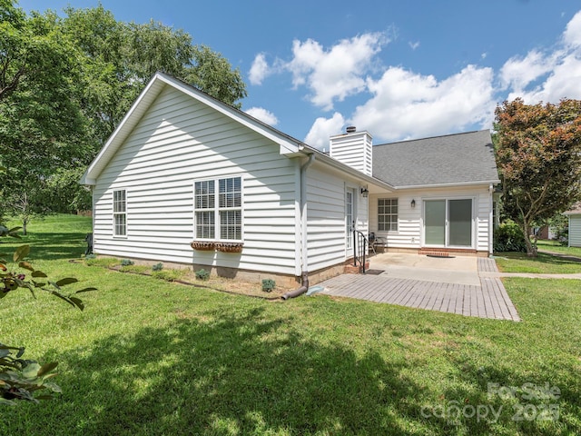 703 Bradberry Ln, Indian Trail, NC 28079 - back of property with a patio, a lawn, and a chimney