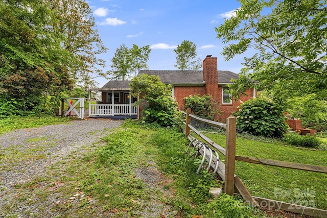 1271 Upper Brush Creek Rd, Fairview, NC 28730 - view of front facade featuring a chimney, brick siding, and roof with shingles