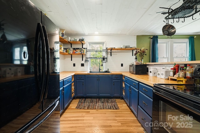 1271 Upper Brush Creek Rd, Fairview, NC 28730 - kitchen with black appliances, butcher block countertops, blue cabinets, open shelves, and light wood-style flooring