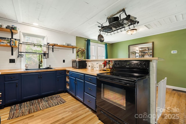 1271 Upper Brush Creek Rd, Fairview, NC 28730 - kitchen featuring black appliances, wooden counters, blue cabinets, open shelves, and light wood-type flooring