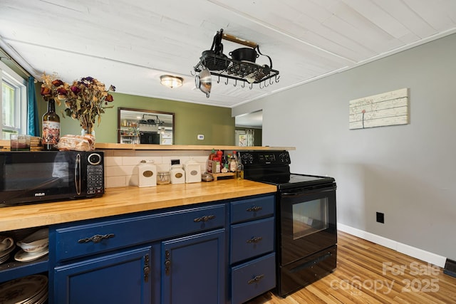 1271 Upper Brush Creek Rd, Fairview, NC 28730 - kitchen with blue cabinetry, black appliances, butcher block countertops, and light wood-type flooring
