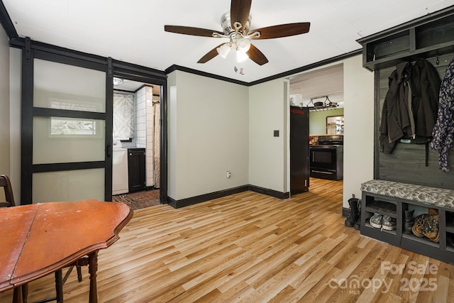 1271 Upper Brush Creek Rd, Fairview, NC 28730 - interior space featuring light wood finished floors, a ceiling fan, crown molding, washer / clothes dryer, and a barn door