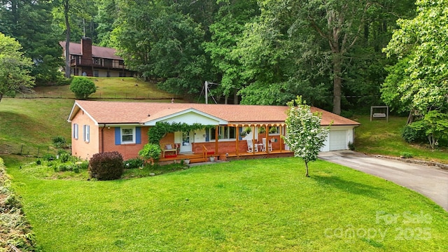 155 John Thomas Dr, Boone, NC 28607 - single story home with covered porch, asphalt driveway, an attached garage, and a front yard