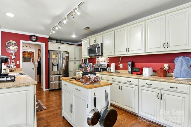 155 John Thomas Dr, Boone, NC 28607 - kitchen with appliances with stainless steel finishes, white cabinets, track lighting, dark wood-style floors, and a center island