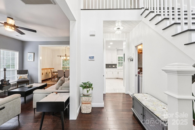 8618 Sam Dee Rd, Charlotte, NC 28215 - living area with a ceiling fan, a chandelier, dark wood-style floors, and stairway