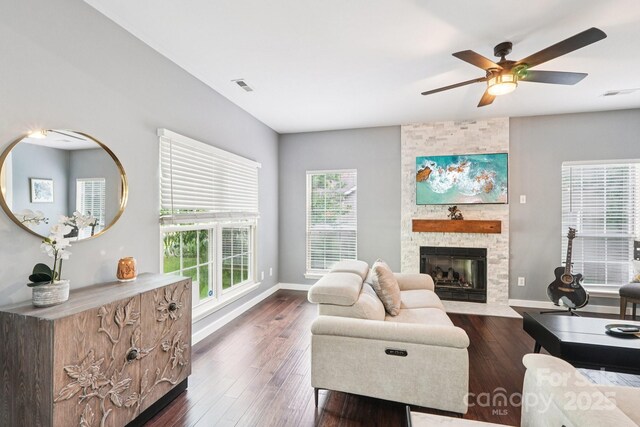 8618 Sam Dee Rd, Charlotte, NC 28215 - living area with a stone fireplace, a ceiling fan, and dark wood-type flooring