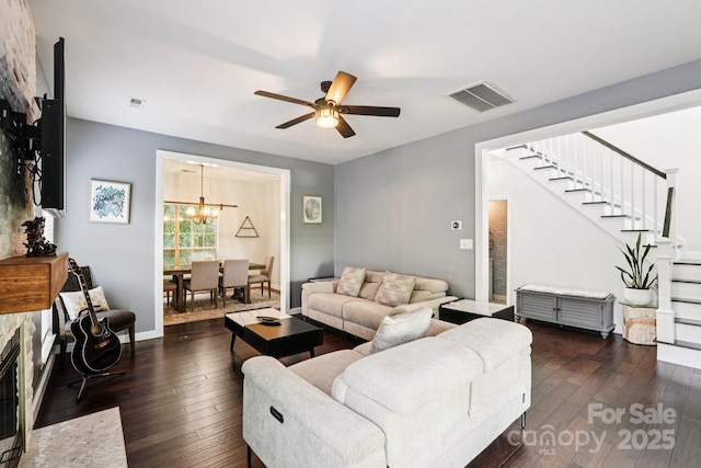 8618 Sam Dee Rd, Charlotte, NC 28215 - living room with stairs, a chandelier, a ceiling fan, and dark wood finished floors