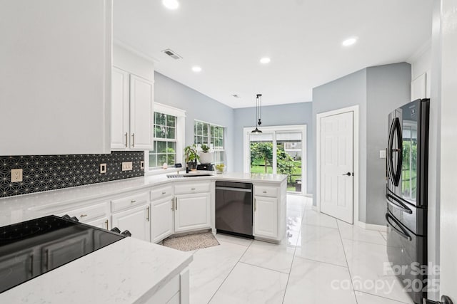 8618 Sam Dee Rd, Charlotte, NC 28215 - kitchen featuring dishwashing machine, freestanding refrigerator, backsplash, white cabinetry, and a peninsula