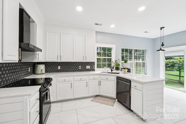 8618 Sam Dee Rd, Charlotte, NC 28215 - kitchen with black appliances, a peninsula, wall chimney exhaust hood, decorative backsplash, and white cabinetry