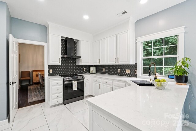 8618 Sam Dee Rd, Charlotte, NC 28215 - kitchen featuring electric range, wall chimney range hood, white cabinetry, backsplash, and recessed lighting