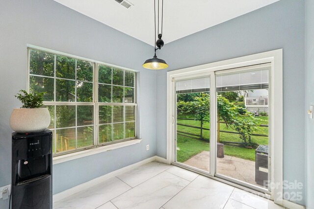 8618 Sam Dee Rd, Charlotte, NC 28215 - unfurnished dining area with healthy amount of natural light and light marble finish floors
