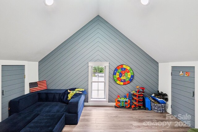 8618 Sam Dee Rd, Charlotte, NC 28215 - living room featuring wood finished floors, vaulted ceiling, and wood walls