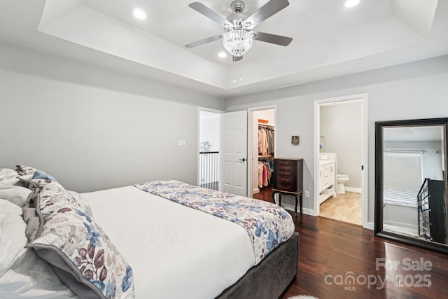 8618 Sam Dee Rd, Charlotte, NC 28215 - bedroom featuring a raised ceiling, dark wood-type flooring, a spacious closet, recessed lighting, and a closet