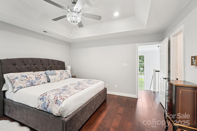 8618 Sam Dee Rd, Charlotte, NC 28215 - bedroom featuring a raised ceiling, dark wood-style flooring, ceiling fan, and recessed lighting