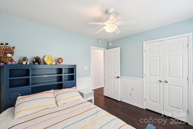 8618 Sam Dee Rd, Charlotte, NC 28215 - bedroom with a wainscoted wall, wood finished floors, a ceiling fan, and a closet