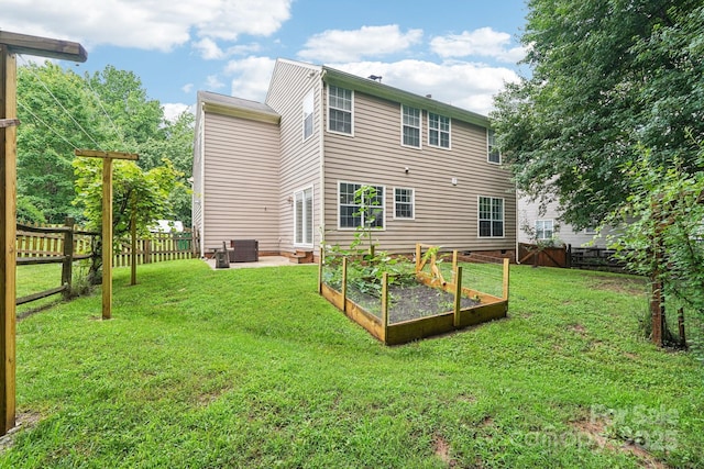 8618 Sam Dee Rd, Charlotte, NC 28215 - rear view of property featuring a vegetable garden and a fenced backyard