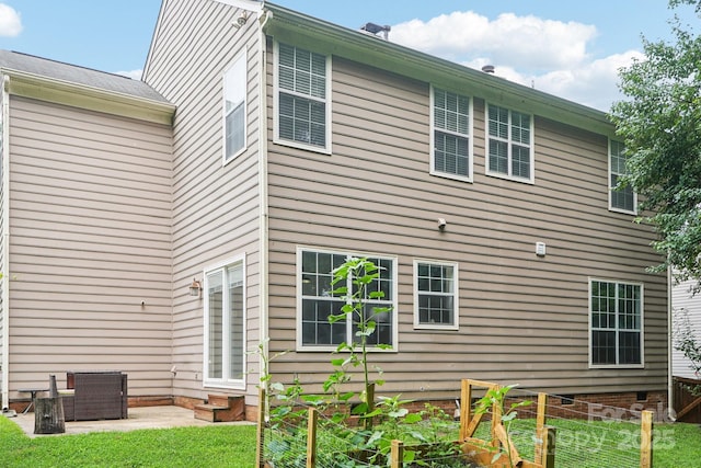 8618 Sam Dee Rd, Charlotte, NC 28215 - rear view of house featuring a vegetable garden, entry steps, and a lawn