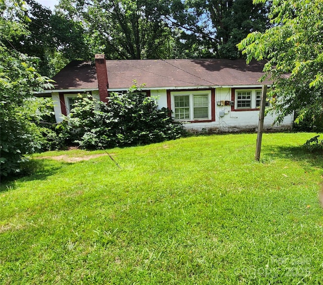 423 Tot Dellinger Rd, Cherryville, NC 28021 - view of front facade featuring a front yard, a chimney, and a shingled roof