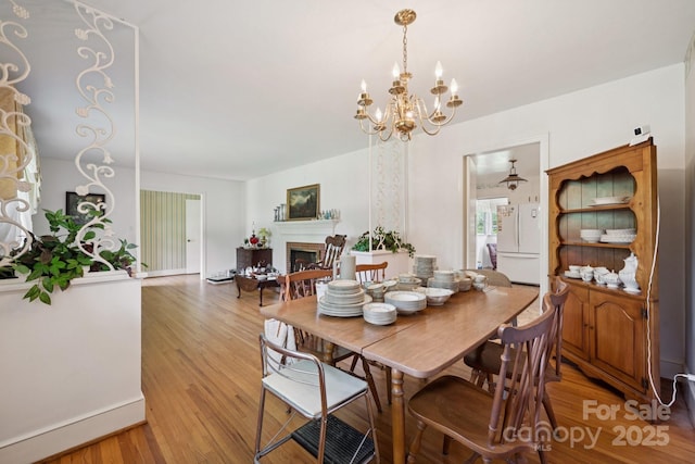 2500 Kendrick Dr, Charlotte, NC 28214 - dining room featuring a chandelier, a fireplace, and light wood-style flooring