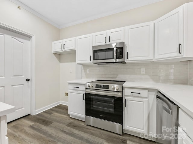 17136 Red Feather Dr, Charlotte, NC 28277 - kitchen with appliances with stainless steel finishes, light countertops, white cabinets, decorative backsplash, and crown molding