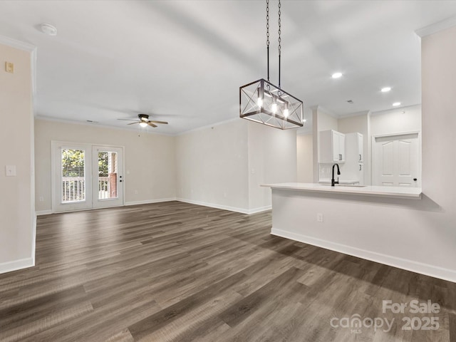 17136 Red Feather Dr, Charlotte, NC 28277 - unfurnished living room featuring crown molding, dark wood-style flooring, ceiling fan, and recessed lighting