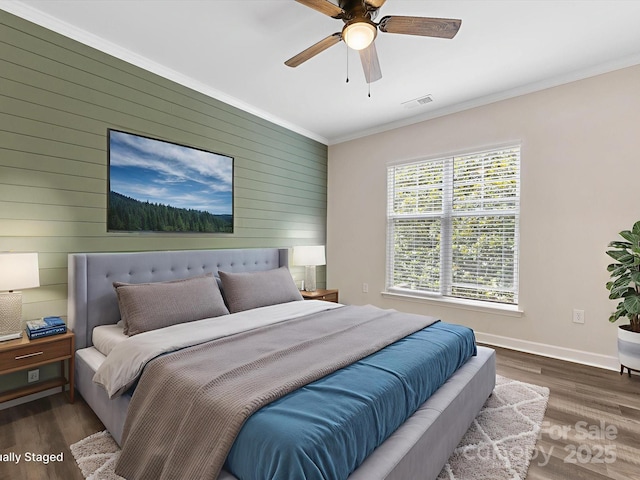 17136 Red Feather Dr, Charlotte, NC 28277 - bedroom with wood walls, crown molding, wood finished floors, and ceiling fan