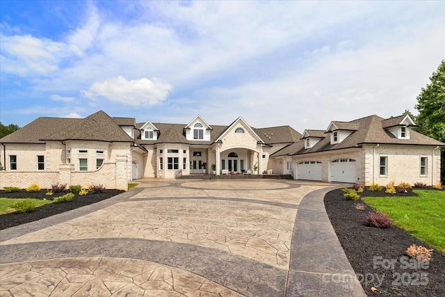 7068 Denison Rd, Summerfield, NC 27358 - french country inspired facade featuring brick siding, curved driveway, a residential view, an attached garage, and a shingled roof